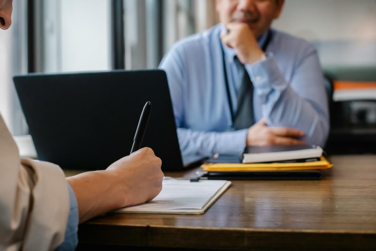 An OKU job candidate reviewing notes and preparing confidently for a job interview
